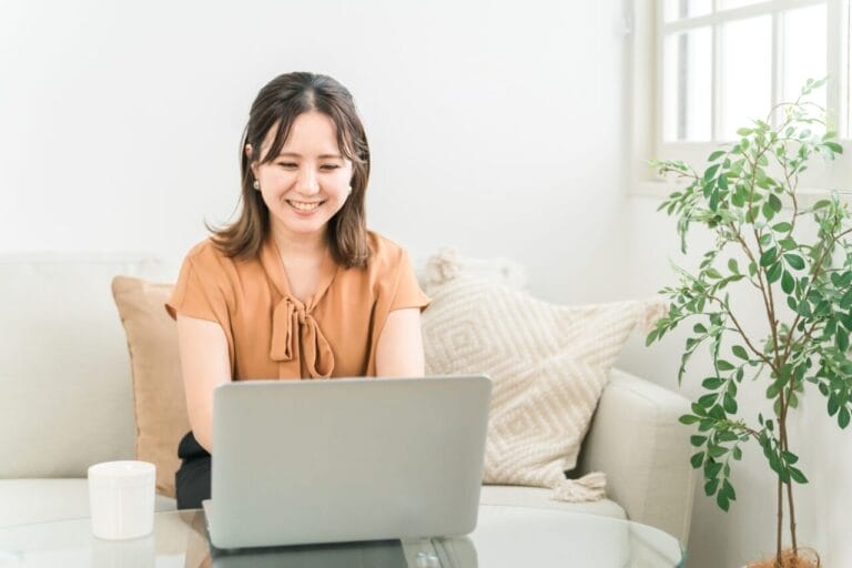 福山で婚活を検討しパソコンで結婚相談所を調べる女性