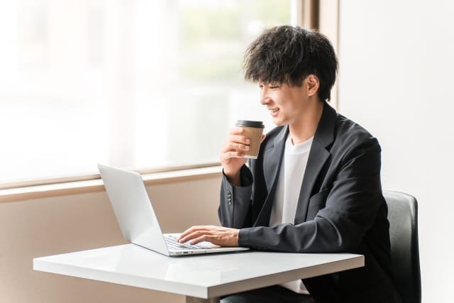 福山市で婚活を検討する男性がパソコンで結婚相談所の情報を調べている様子